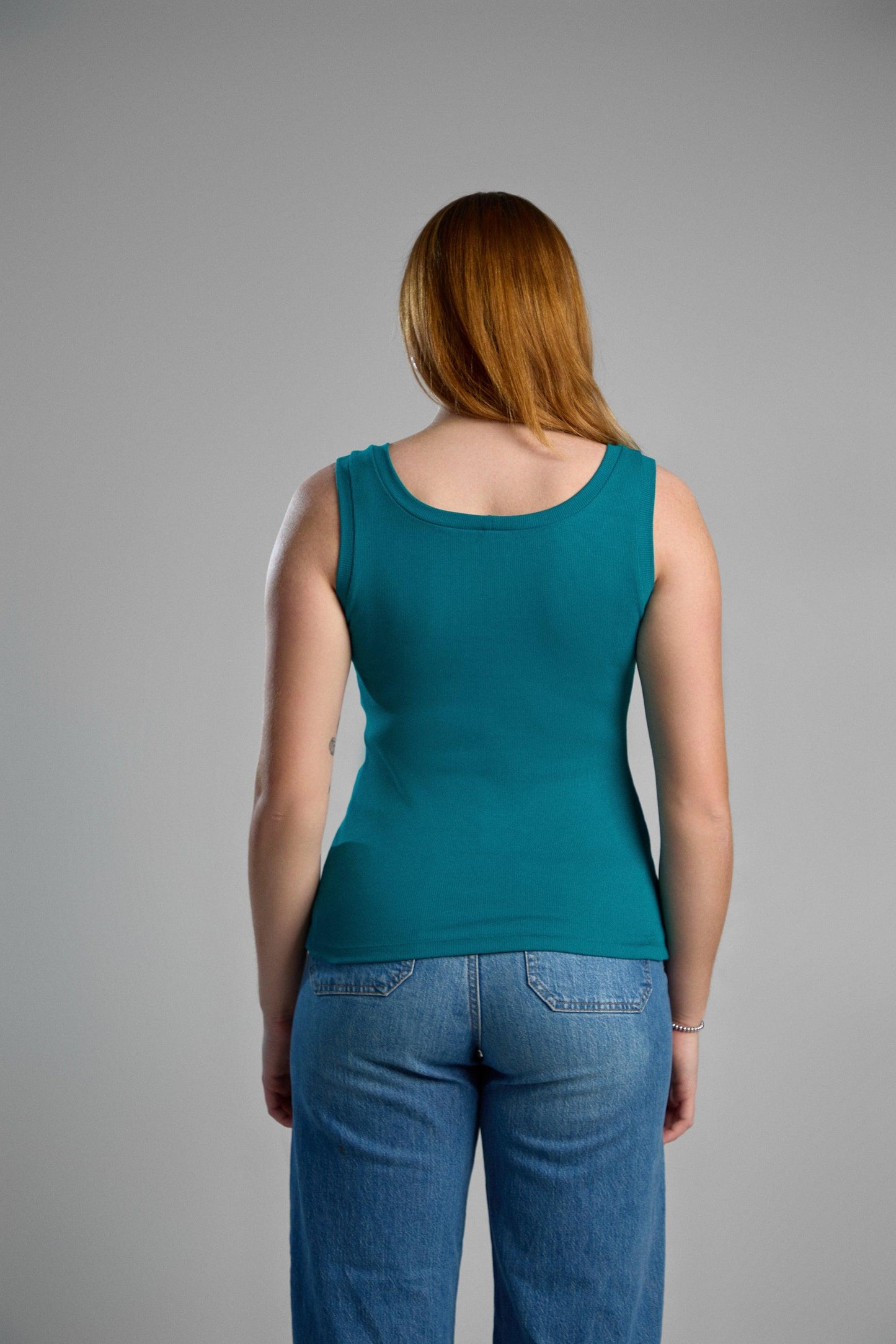 A stylish, green tank top made from recycled cotton, emphasizing eco-friendly materials and comfortable fit.