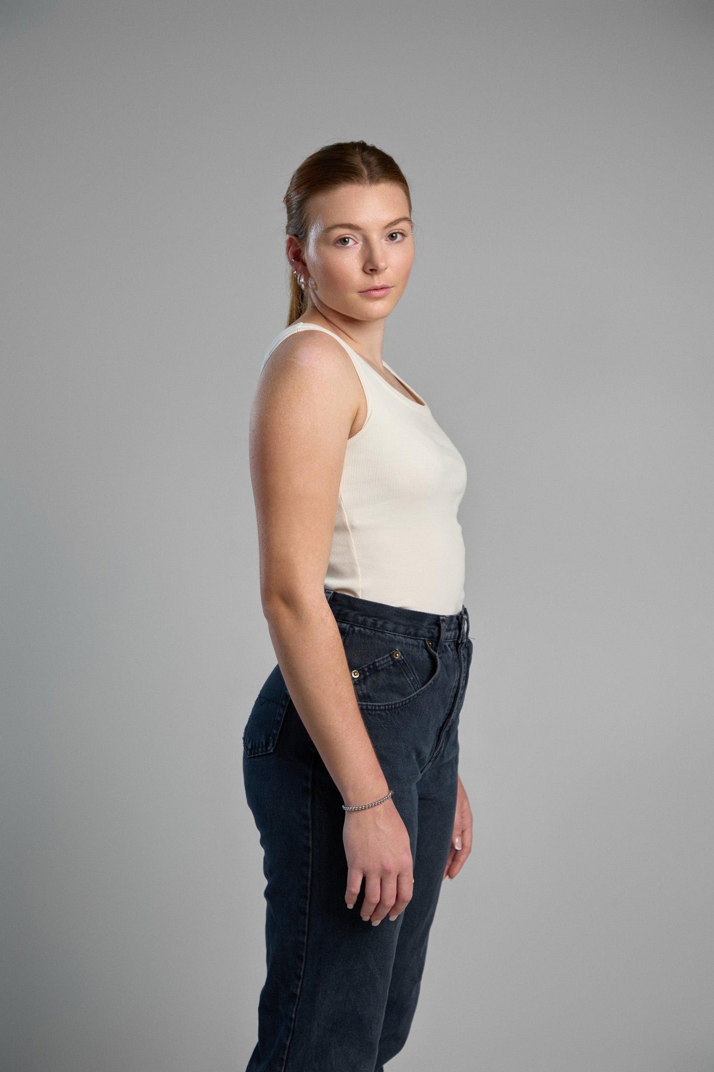 A stylish, ivory tank top made from recycled cotton, emphasizing eco-friendly materials and comfortable fit.