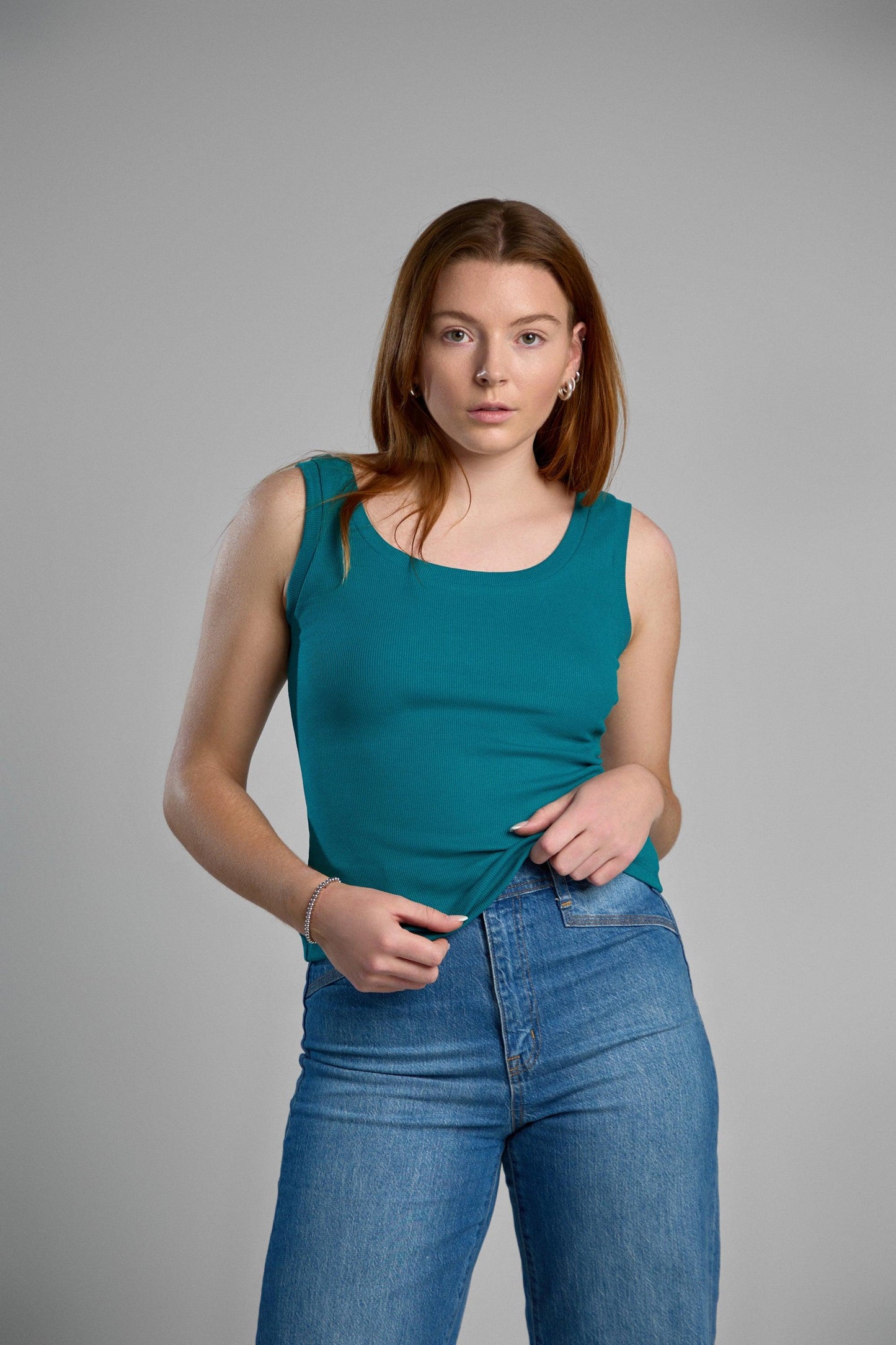 A stylish, green tank top made from recycled cotton, emphasizing eco-friendly materials and comfortable fit.