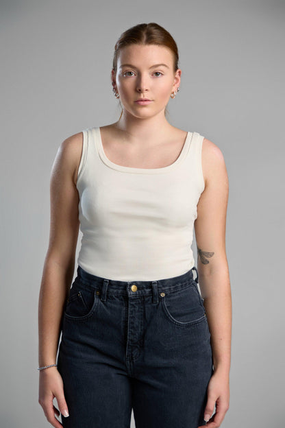 A stylish, ivory tank top made from recycled cotton, emphasizing eco-friendly materials and comfortable fit.