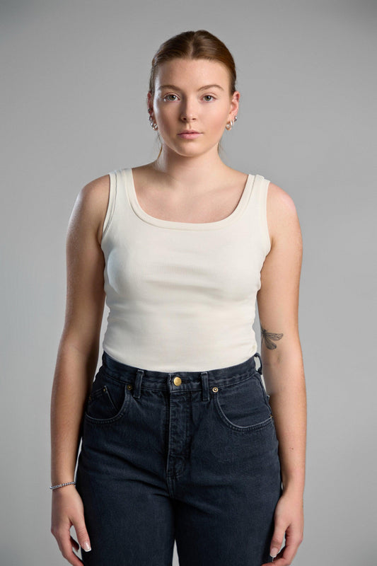 A stylish, ivory tank top made from recycled cotton, emphasizing eco-friendly materials and comfortable fit.